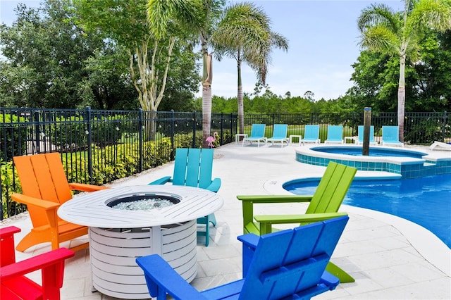 exterior space featuring a swimming pool with hot tub and a patio