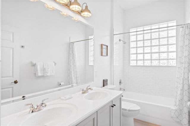 full bathroom featuring shower / bath combination with curtain, toilet, and vanity