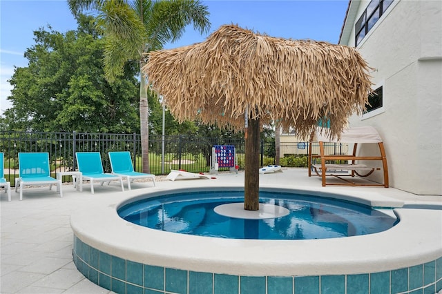 view of swimming pool featuring fence