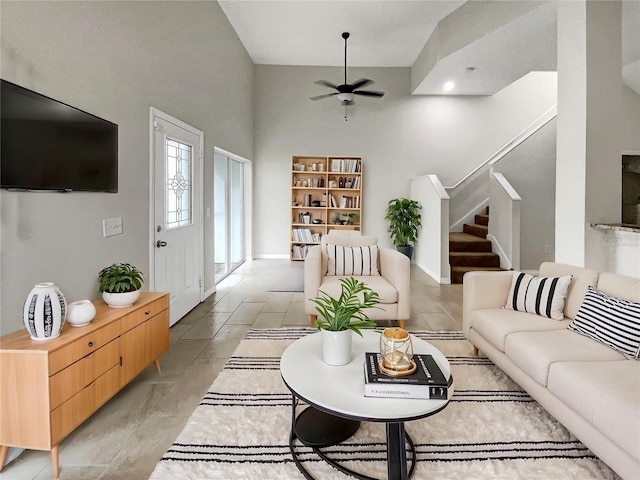 living room with stairs and a ceiling fan