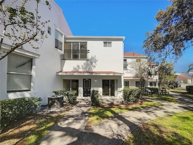 view of front of house featuring stucco siding and central AC unit