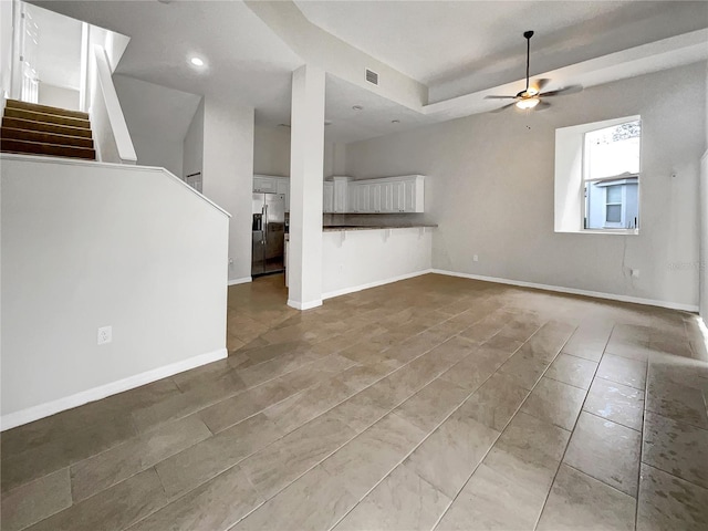 unfurnished living room with recessed lighting, baseboards, stairs, and ceiling fan