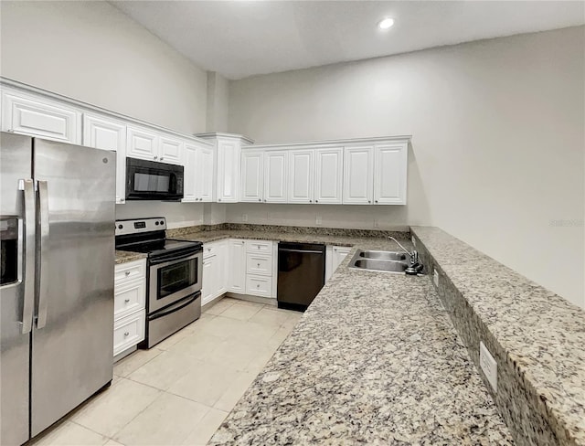 kitchen featuring black appliances, stone counters, recessed lighting, white cabinetry, and a sink