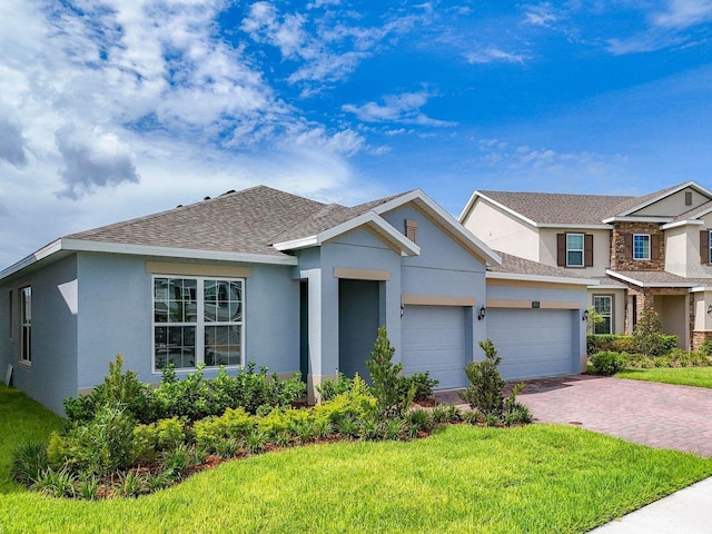 view of front of property featuring a garage and a front lawn