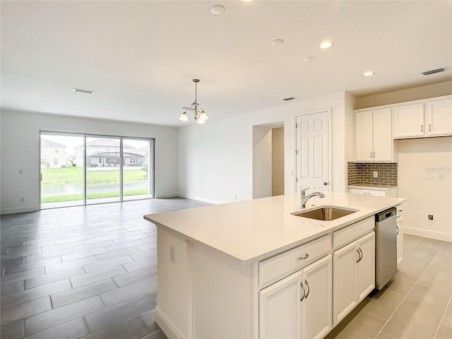 kitchen with white cabinets, a kitchen island with sink, sink, pendant lighting, and dishwasher