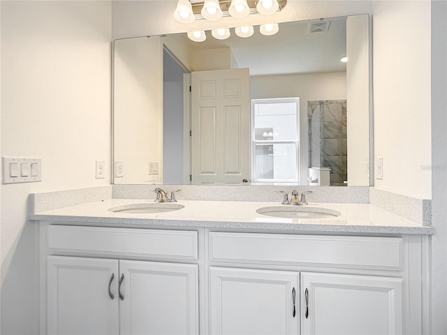 bathroom featuring vanity and an enclosed shower