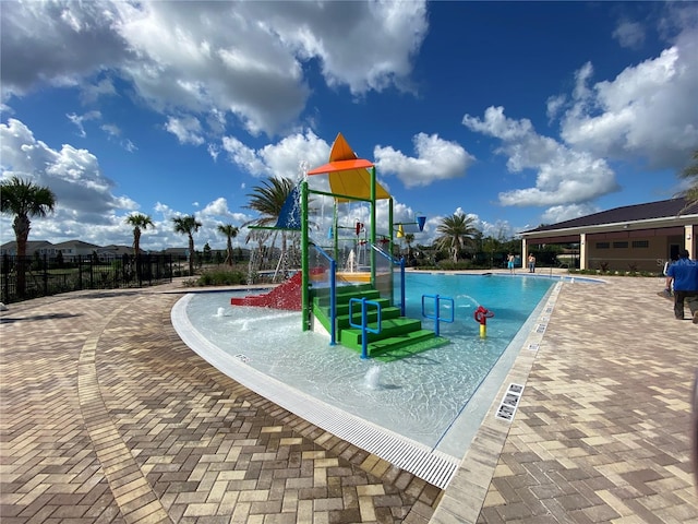 view of jungle gym featuring a community pool