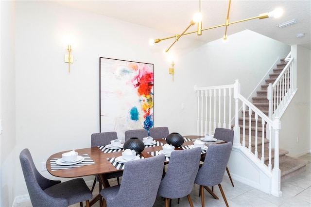 tiled dining area featuring a notable chandelier