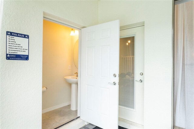 unfurnished bedroom featuring light tile floors