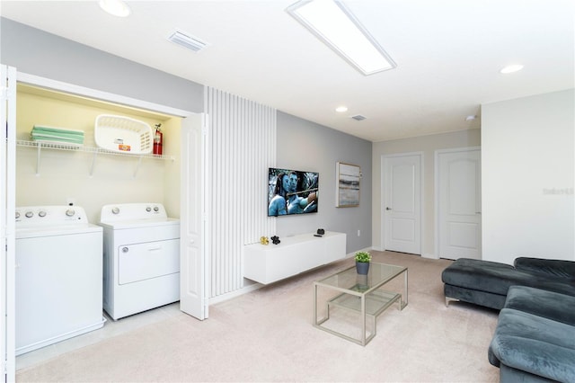 carpeted living room with separate washer and dryer