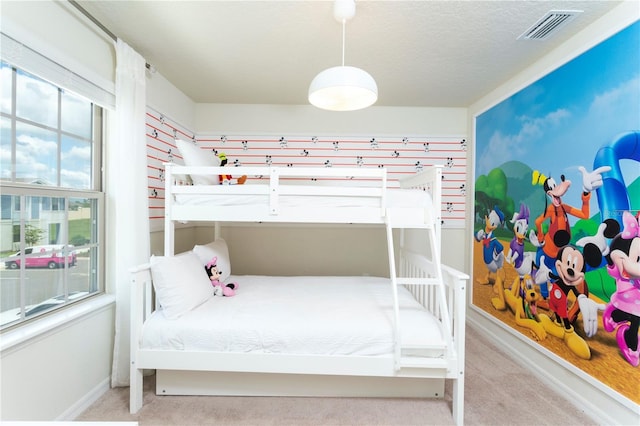 carpeted bedroom featuring a textured ceiling