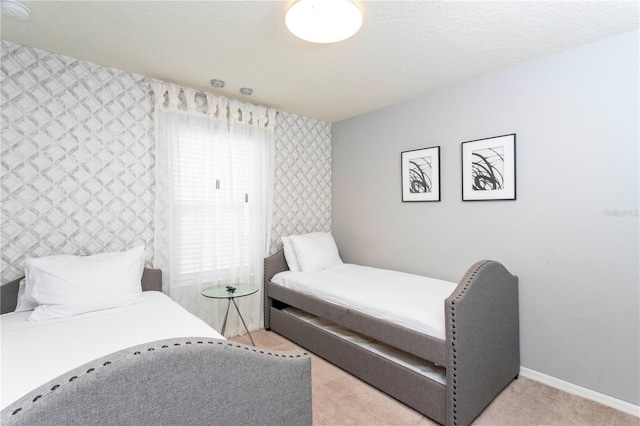 carpeted bedroom featuring multiple windows and a textured ceiling