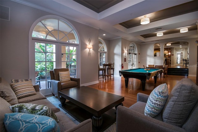 game room featuring a tray ceiling, hardwood / wood-style flooring, ornamental molding, and pool table