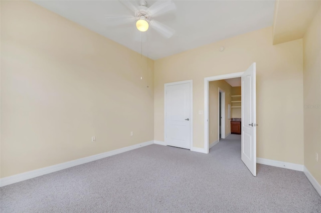 unfurnished room featuring light colored carpet and ceiling fan