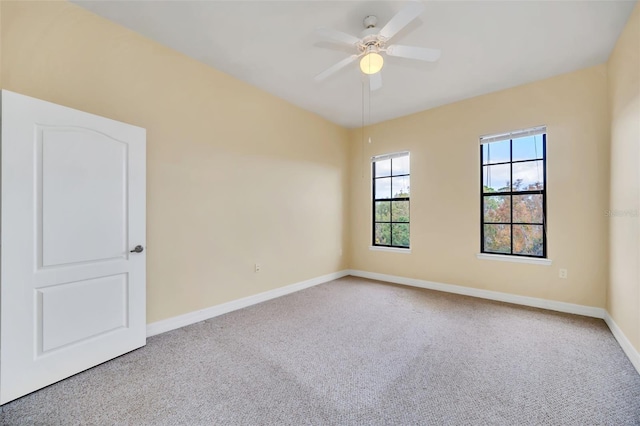 carpeted spare room with ceiling fan