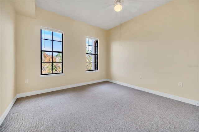 empty room featuring ceiling fan and carpet floors