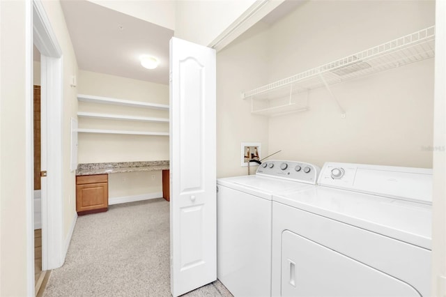 laundry area featuring separate washer and dryer and light colored carpet