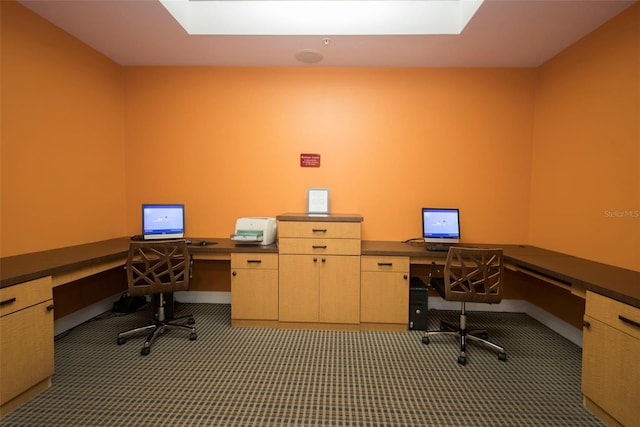 carpeted office featuring built in desk