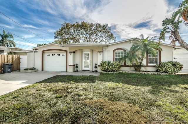 ranch-style home featuring a front yard and a garage