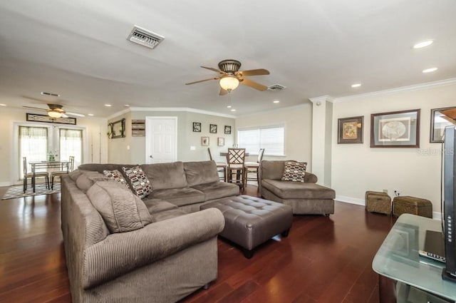 living room featuring ceiling fan, dark wood-type flooring, and a healthy amount of sunlight