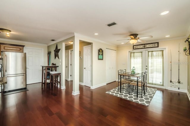 dining area with dark hardwood / wood-style floors, ornamental molding, ceiling fan, and french doors