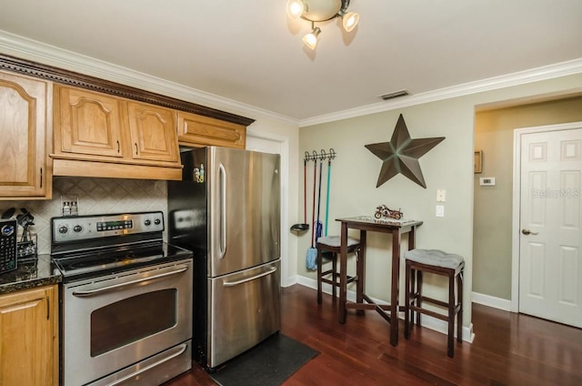 kitchen with dark hardwood / wood-style floors, dark stone counters, crown molding, stainless steel appliances, and tasteful backsplash