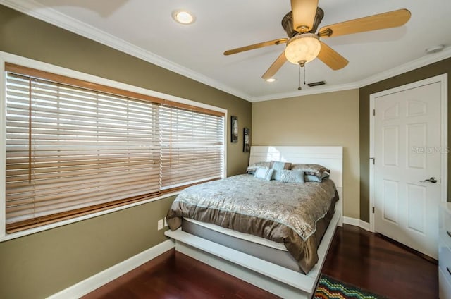 bedroom with crown molding, ceiling fan, and dark wood-type flooring