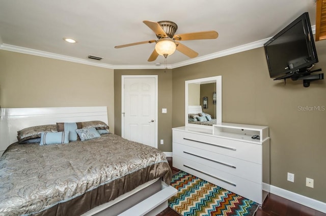 bedroom featuring dark wood-type flooring, ornamental molding, and ceiling fan