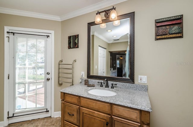 bathroom with vanity, plenty of natural light, and ornamental molding