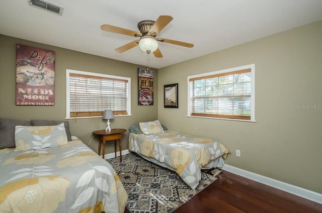 bedroom with ceiling fan and dark hardwood / wood-style flooring