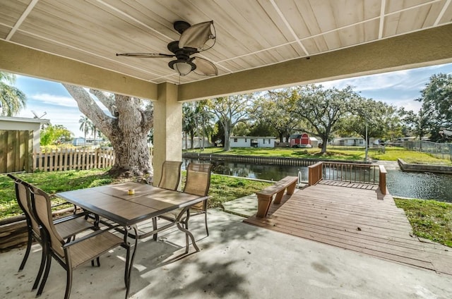 view of terrace featuring a water view and ceiling fan