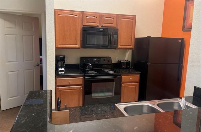 kitchen with black appliances and dark stone countertops