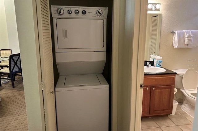 laundry area with sink, stacked washing maching and dryer, and light colored carpet