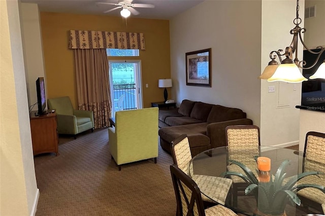 living room featuring ceiling fan and dark colored carpet