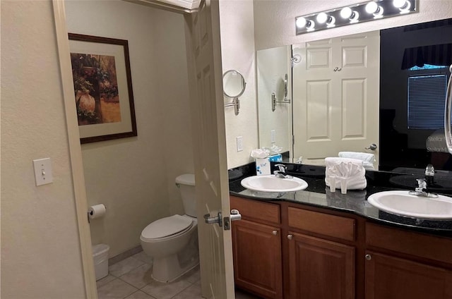 bathroom with vanity, tile patterned floors, and toilet