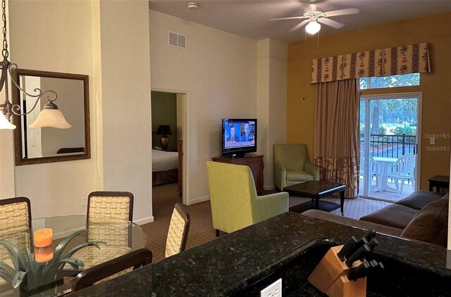 living room with carpet flooring and ceiling fan