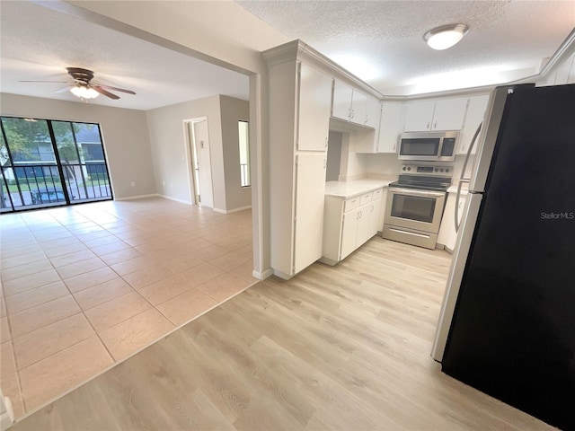 kitchen with white cabinetry, ceiling fan, light hardwood / wood-style flooring, and appliances with stainless steel finishes