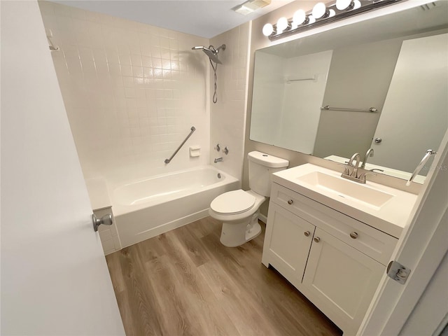 full bathroom featuring wood-type flooring, vanity, toilet, and tiled shower / bath