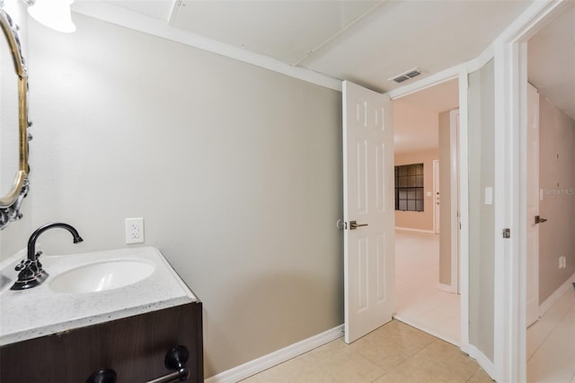 bathroom featuring tile patterned flooring and vanity