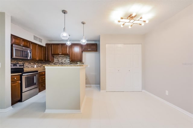 kitchen with decorative backsplash, appliances with stainless steel finishes, and decorative light fixtures