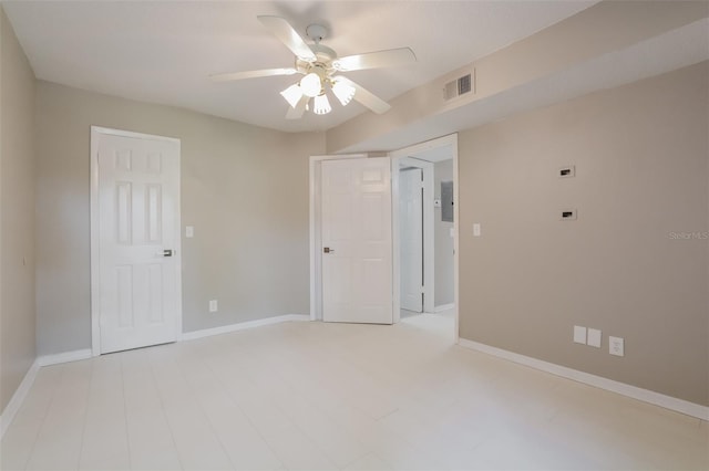 spare room featuring electric panel and ceiling fan