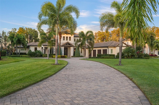 mediterranean / spanish house with a front lawn