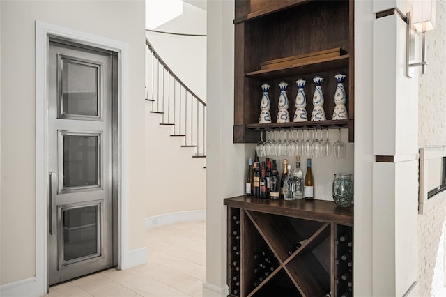 6109 Orta Ct, Windermere, FL 34786 - bar with light tile patterned floors, baseboards, and stairway