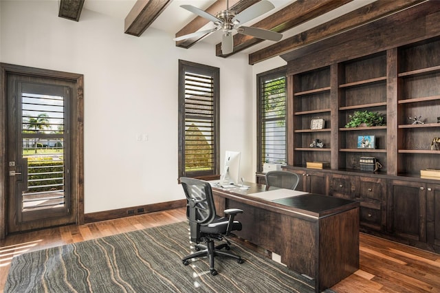 home office with ceiling fan, beamed ceiling, and dark hardwood / wood-style flooring