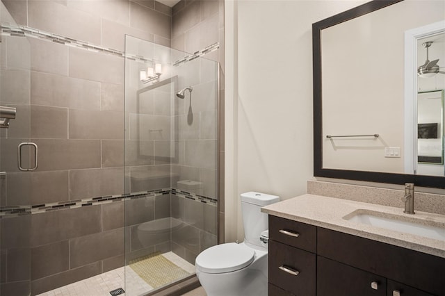 bathroom featuring vanity, toilet, and an enclosed shower