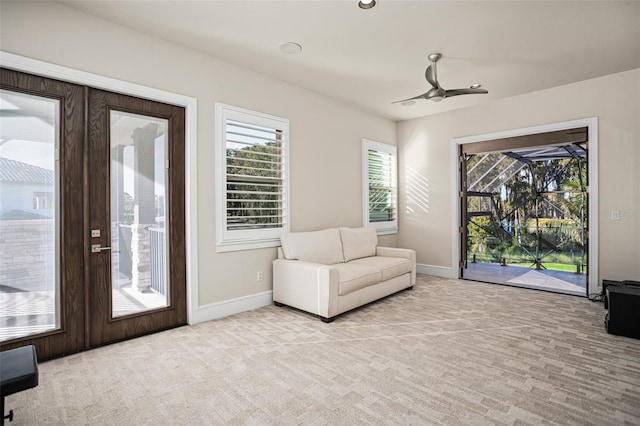 unfurnished room featuring french doors, light colored carpet, and ceiling fan