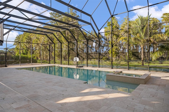 view of swimming pool featuring an in ground hot tub, a patio, and glass enclosure