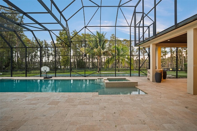 view of pool featuring an in ground hot tub, a patio, and glass enclosure