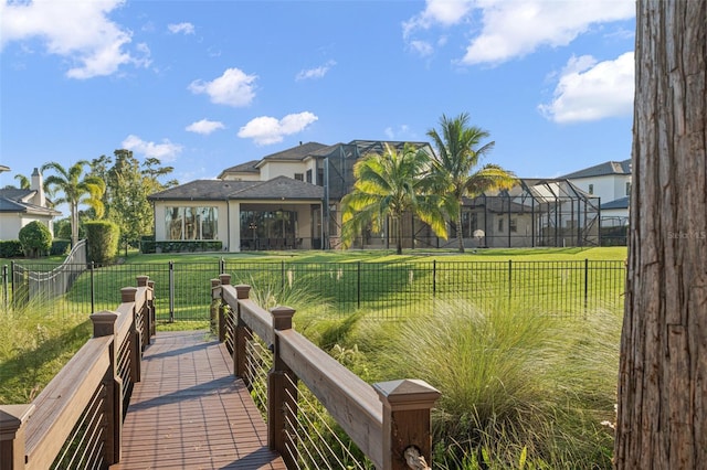 exterior space with a yard and glass enclosure