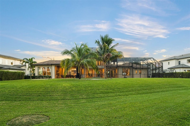 6109 Orta Ct, Windermere, FL 34786 - rear view of house with a yard and glass enclosure